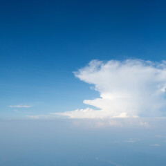 Naklejka na ściany i meble Aerial view of sky above the clouds