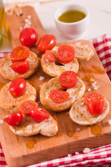 Friselle with cherry tomatoes and olive oil.