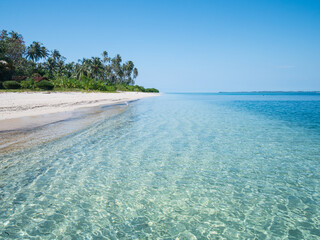 White sand beach with coconut palm trees turquoise blue water coral reef, tropical travel destination, desert beach no people - Banyak Islands, Sumatra, Indonesia