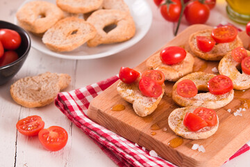 Friselle with cherry tomatoes and olive oil.
