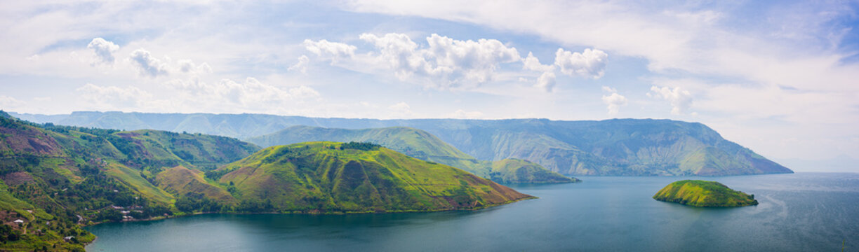 Lake Toba and Samosir Island view from above Sumatra Indonesia. Huge volcanic caldera covered by water, traditional Batak villages, green rice paddies, equatorial forest.