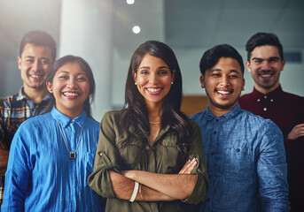 We boast a track record of multiple successes. Portrait of a team of confident young designers standing together in an office.