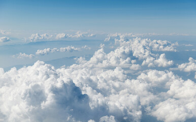 Top view cloudy mountains from a plane