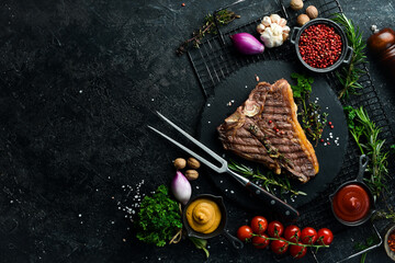 porterhouse steak or T Bone Steak dry aged of beef Ready to Cook on wooden Board with herbs, pepper...