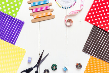 Border made with various fabric and sewing tools on a white wooden table