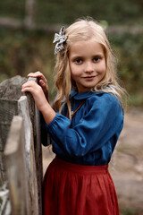 a portrait of cute children in beautiful dress on a farm
