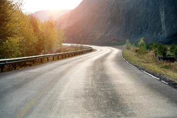 Straight road in summer and early autumn forest at sunset in China