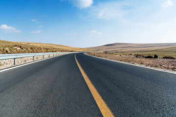 Empty asphalt highway and blue sky