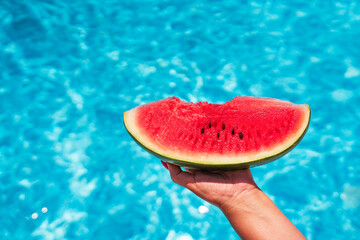 Watermelon slice near the pool in summer day
