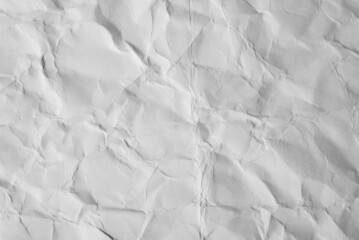 Obraz premium Close-up of crumpled sheet of white paper. Top view textured uneven paper background, macro photography