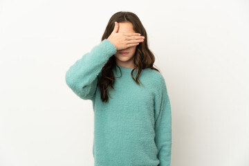 Little caucasian girl isolated on white background covering eyes by hands. Do not want to see...