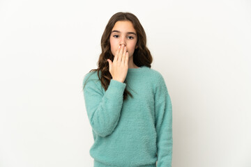 Little caucasian girl isolated on white background covering mouth with hand