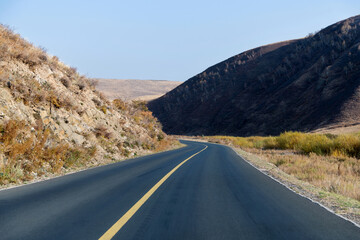 Country road through the hill in the autumn