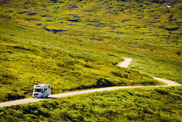 Camper car on road in norwegian mountains