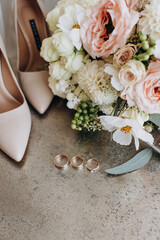 wedding rings with precious stones on the background of the bride's bouquet