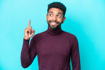 Fototapeta premium Young Brazilian man isolated on blue background thinking an idea pointing the finger up