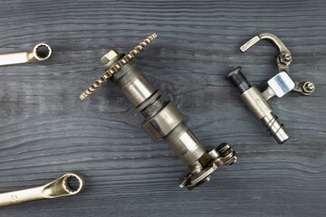 Spare parts for motorcycles and cars, wrenches. Removal and installation of new and old parts.