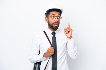 Young architect Brazilian man with helmet and holding blueprints isolated on white background thinking an idea pointing the finger up