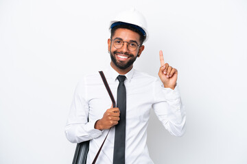 Young architect Brazilian man with helmet and holding blueprints isolated on white background pointing up a great idea