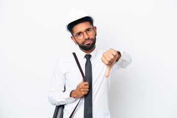 Young architect Brazilian man with helmet and holding blueprints isolated on white background showing thumb down with negative expression