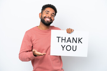 Young Brazilian man isolated on white background holding a placard with text THANK YOU making a deal