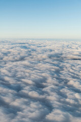 Fototapeta na wymiar Looking at the cloudscape through airplane window