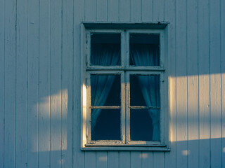 Fototapeta premium old window of an abandoned farmhouse in the evening light