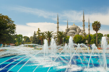 The Sultan Ahmed Mosque (Blue Mosque) and fountain view from the Sultanahmet Park in Istanbul, Turkey
