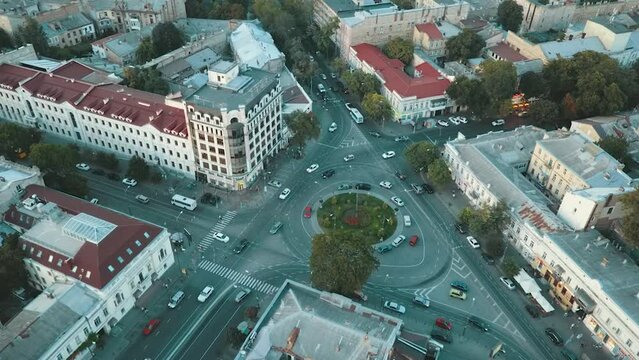 Tiraspol square, cars drive around, people walk around.