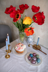 Festive Easter cakes with white icing and sugar decor on a table decorated in spring style