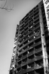 A destroyed high-rise building of people in Kharkov after the shelling of Russian troops. Black and...