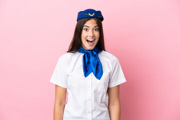 Airplane stewardess Brazilian woman isolated on pink background with surprise facial expression