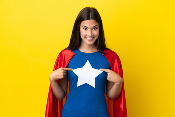 Super Hero Brazilian woman isolated on yellow background with surprise facial expression