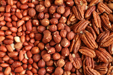 Raw peeled peanuts, hazelnuts, pecans on a linen cloth. Closeup. Macro