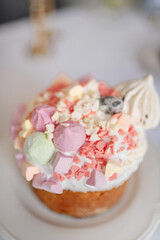 Festive Easter cakes with white icing and sugar decor on a table decorated in spring style