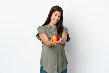 Young Brazilian woman isolated on white background pregnant and holding an apple