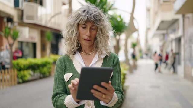Middle age woman smiling confident standing at street