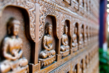 Group of Buddha statues on the wall