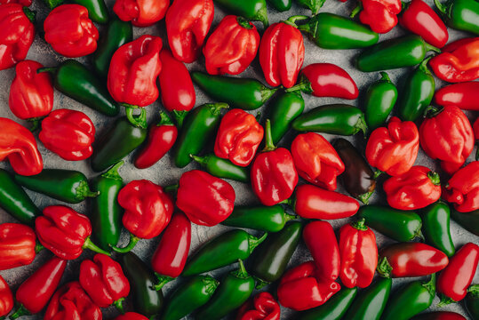 Ripe Habanero and Jalapeno Chili Peppers on Concrete Background
