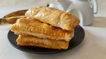 Home baked sweet plantain puffs made with ripe plantain and store bought puff pastry sheets