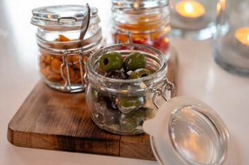 Glass jars with healthy party snacks served in bar, tasty appetisers