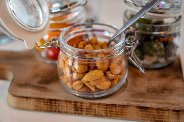 Glass jars with healthy party snacks served in bar, tasty appetisers