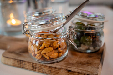 Glass jars with healthy party snacks served in bar, tasty appetisers
