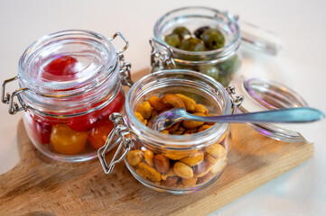 Glass jars with healthy party snacks served in bar, tasty appetisers