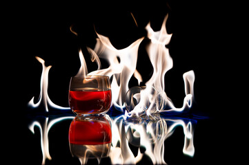 Alcoholic drink Whiskey with a glass on its side on a reflective surface with beautiful white...