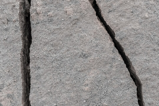 Large crack after earthquake on the soil surface of the earth damaged ground background climate pattern