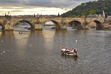 Famous bridge in Prague called Karlův most or charles bridge over the river Vltava with a small...