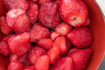 a bowl of fresh organic frozen strawberries used for smoothie