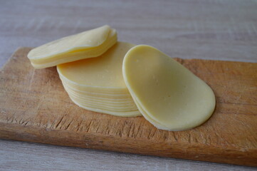 Sliced Cheese on wooden background