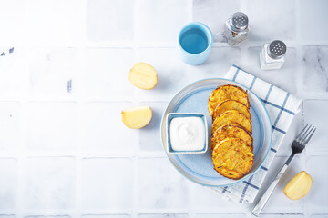 Potato hash browns with sour cream sauce in a plate